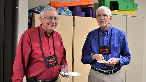 Two senior adults sharing a meal in a classroom