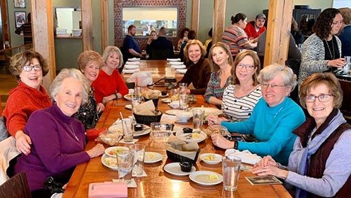 A group of women easting lunch at a restaurant