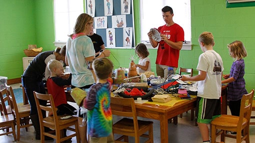 Teachers leading kids in craft activity