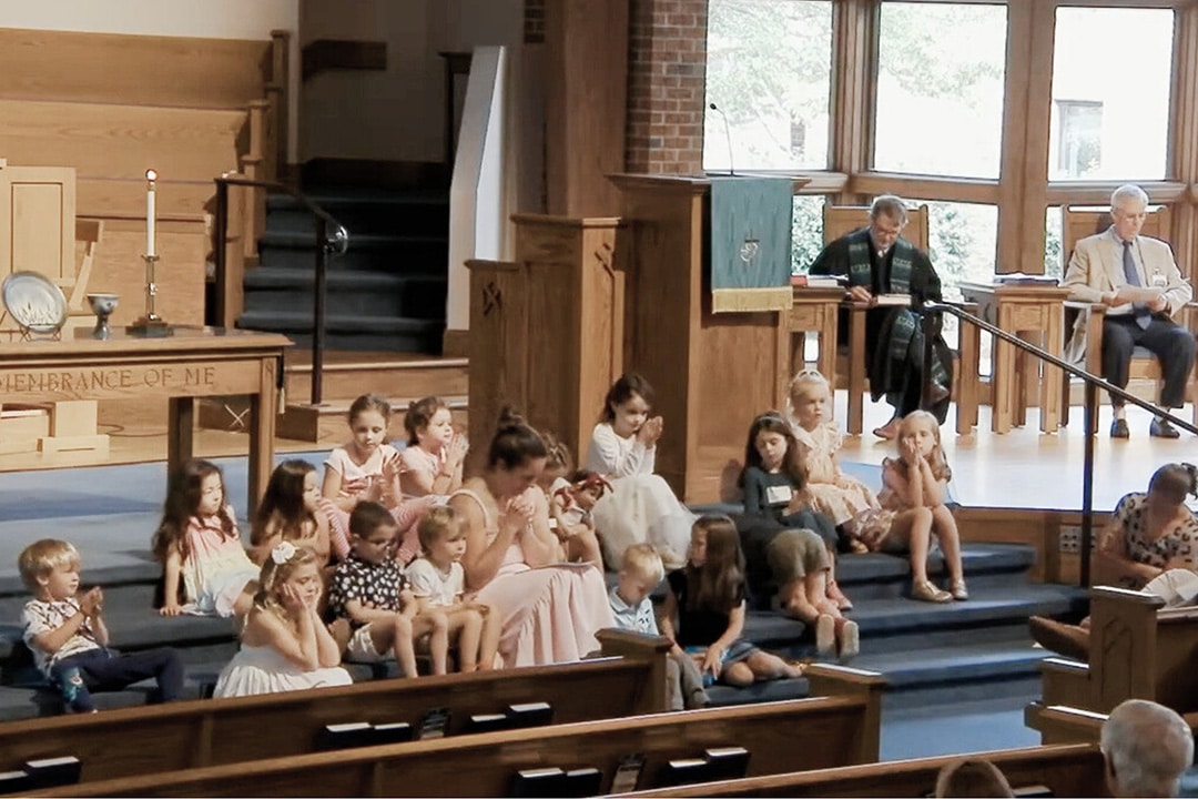 Two kids eating a meal inside of a SUV