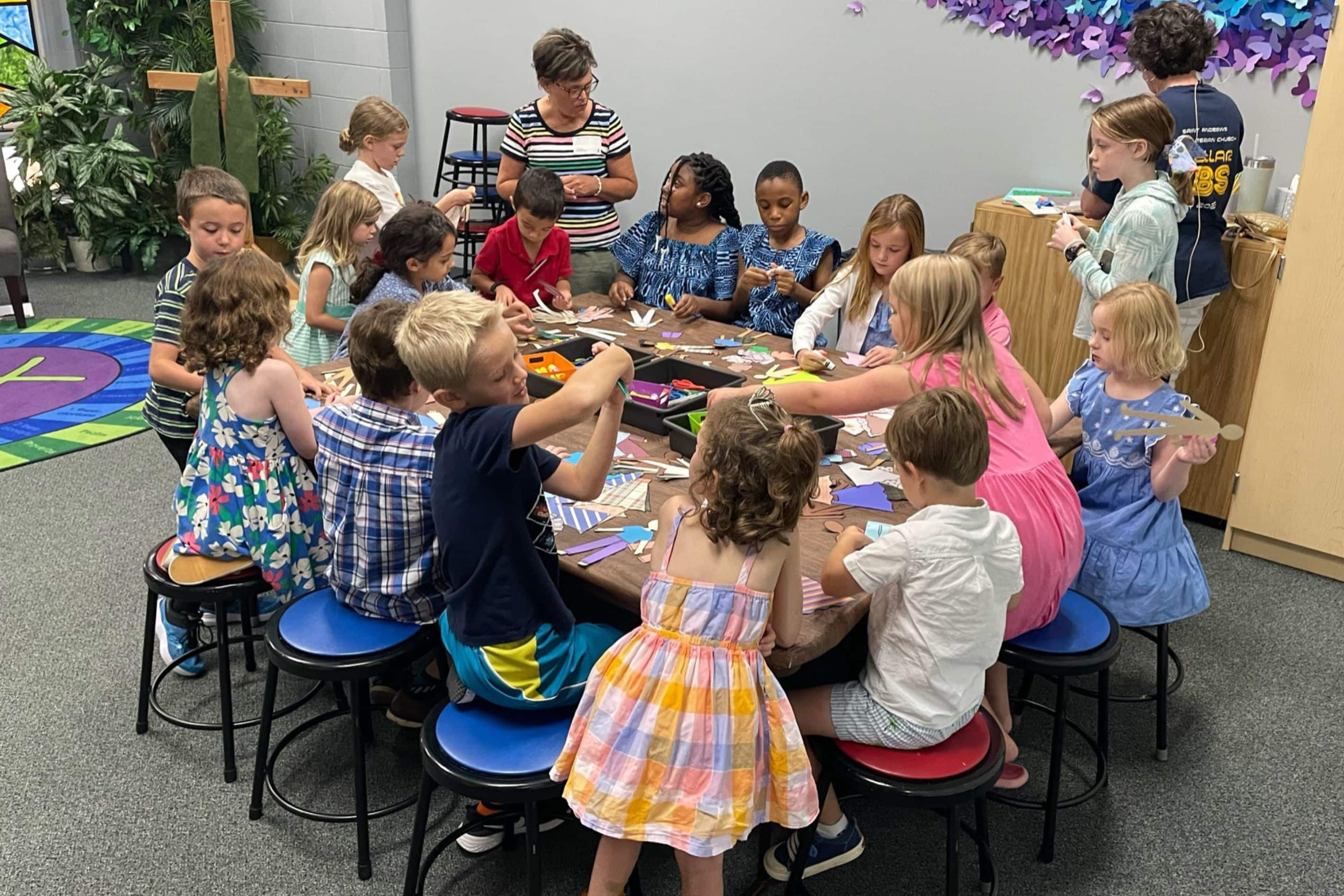 Teachers leading kids in craft activity