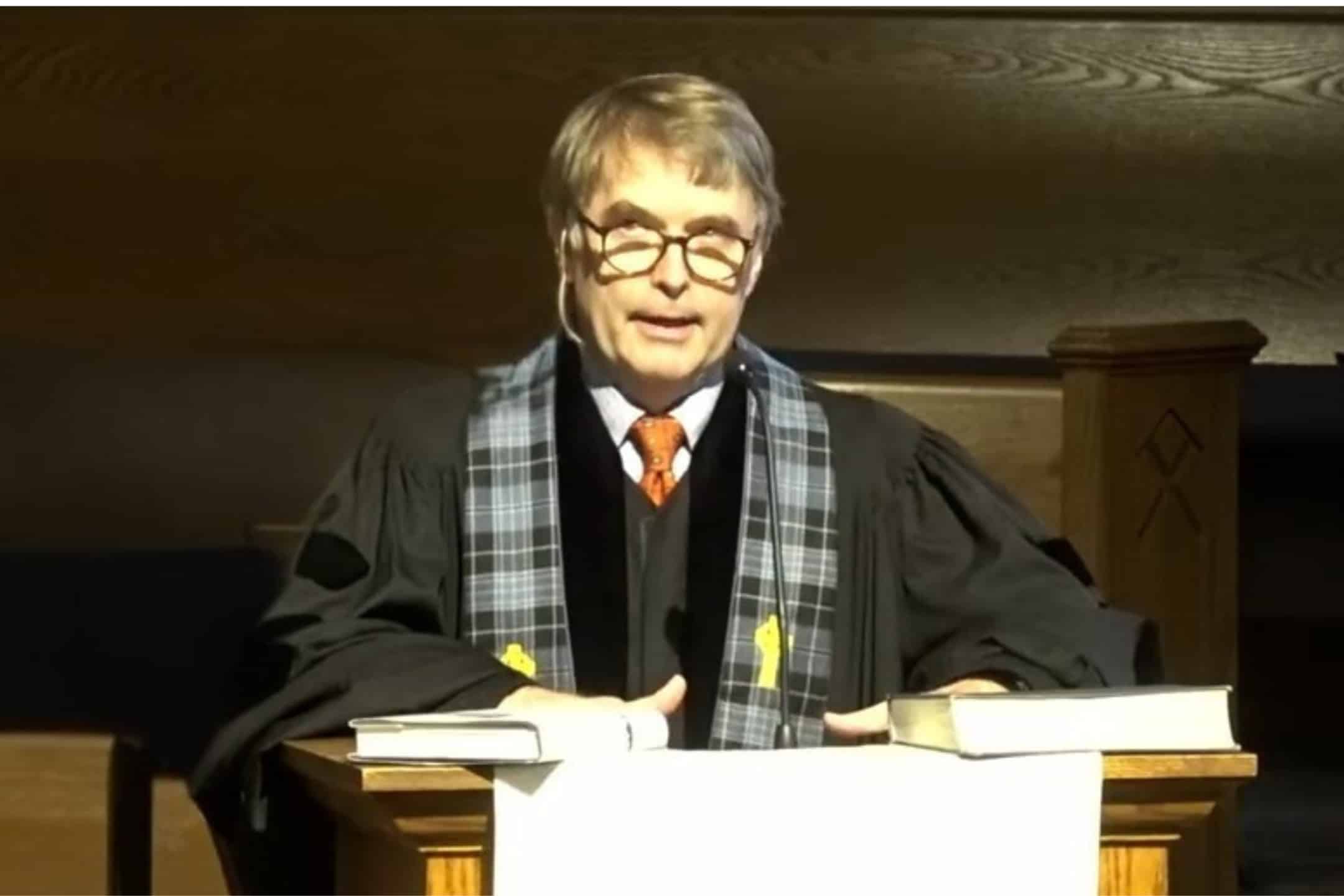 Mother and son wearing masks near their red car